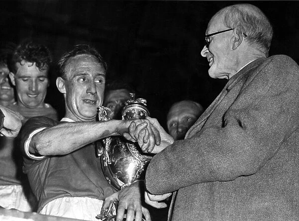 Aloysius McGowan, the Wrexham captain, receives the Welsh Cup from Mr E