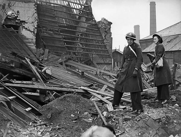Ambulance drivers survey the remains of their first-aid post, in Aston, Birmingham