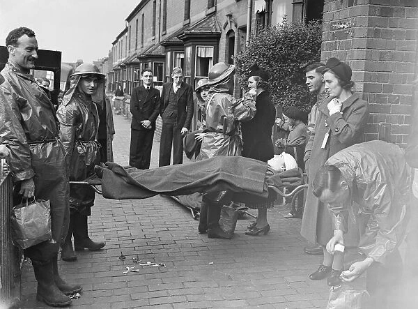 Ambulance men, ARP wardens and members of the public taking part in a air raid exercise