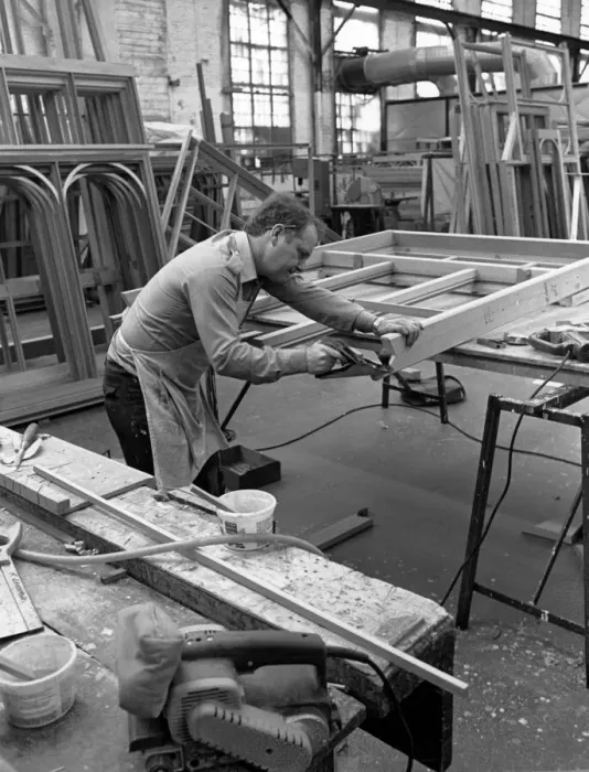 Framed Print : Amdega Conservatories. Joiner puts the finishing touches to one of the joints of a