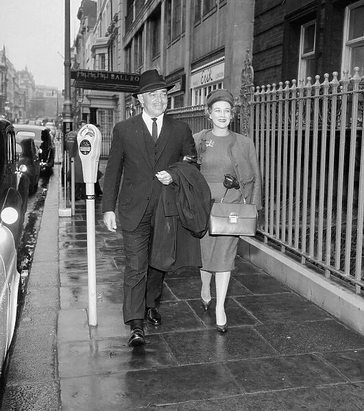 American actor Clark Gable with his wife walking through a London street with his wife