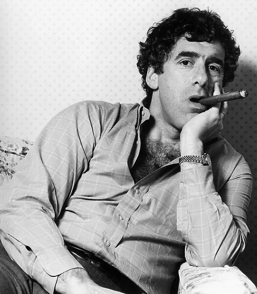 American actor Elliott Gould poses smoking a cigar. January 1984
