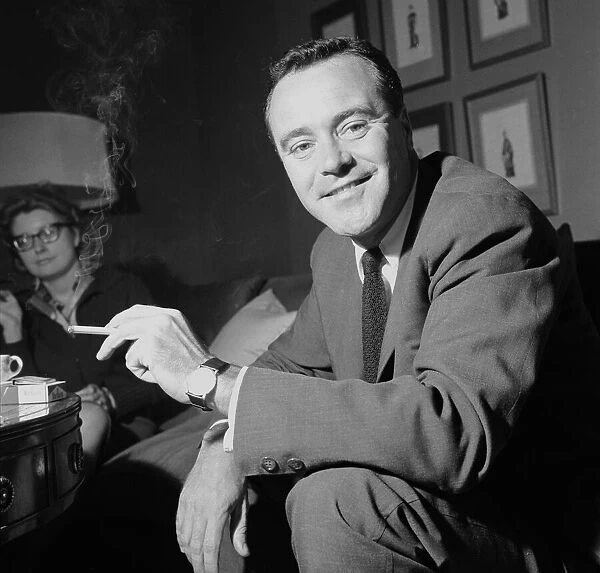 American actor Jack Lemmon smoking a cigarette during a press reception at the Mayfair