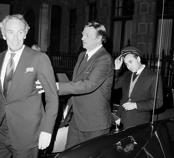 American actor John Wayne leaving the Ambassadeurs Club in Hamilton Place