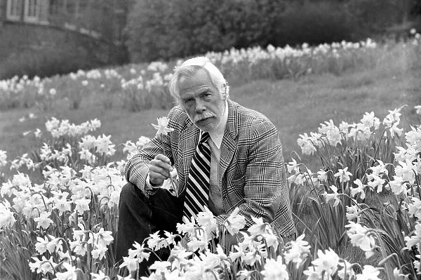 American actor Lee Marvin smelling the spring flowers during a visit to England