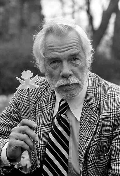 American actor Lee Marvin amongst the spring flowers during a visit to England