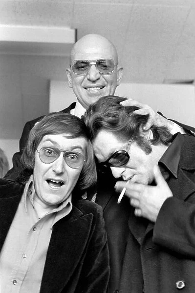 American actor Telly Savalas with Yin (left) and Yan, two pop singers who have made a