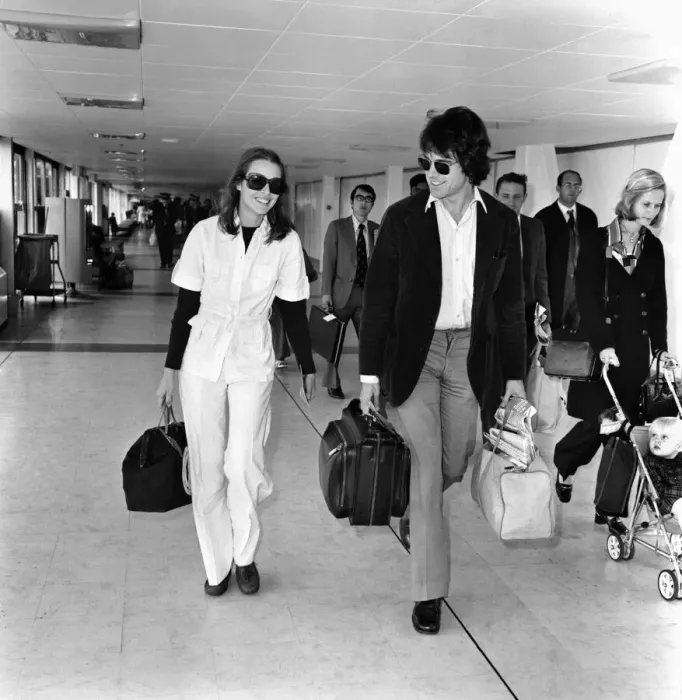 Framed Print : American actor Warren Beatty at Heathrow Airport with Michelle Phillips. May 1975 Framed Print : American actor Warren Beatty at Heathrow Airport with Michelle Phillips. May 1975