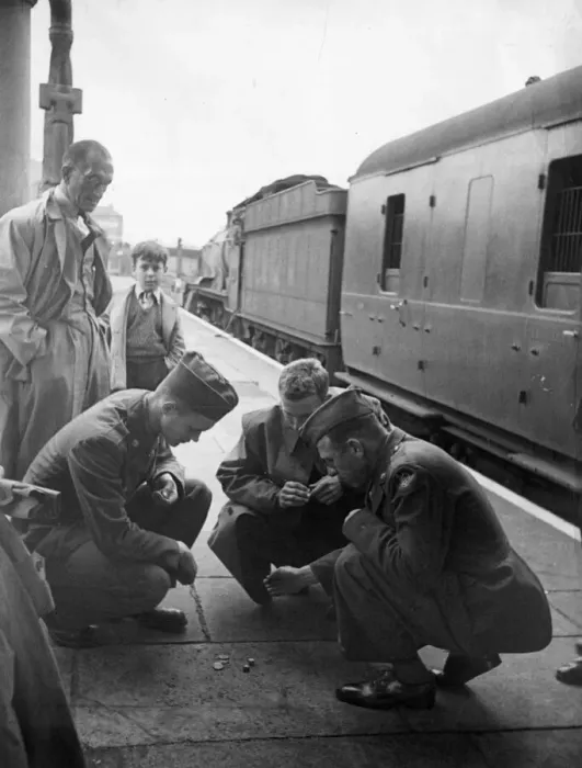 Framed Print : American army soldiers while away the time waiting for a train to leave Framed Print : American army soldiers while away the time waiting for a train to leave