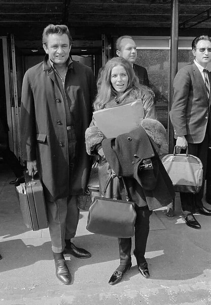 American country singer Johnny Cash with his wife June Carter arriving at Heathrow