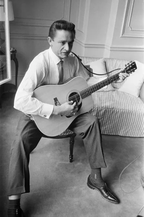 Framed Print : American country singer and musician Johnny Cash poses for photographers at the Savoy