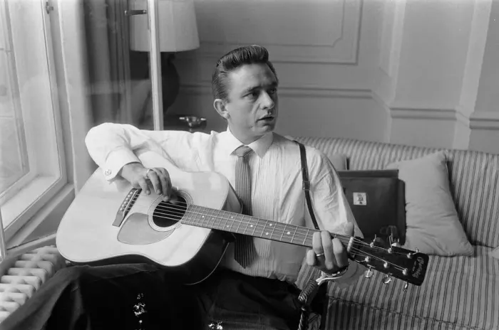 Framed Print : American country singer and musician Johnny Cash poses for photographers at the Savoy