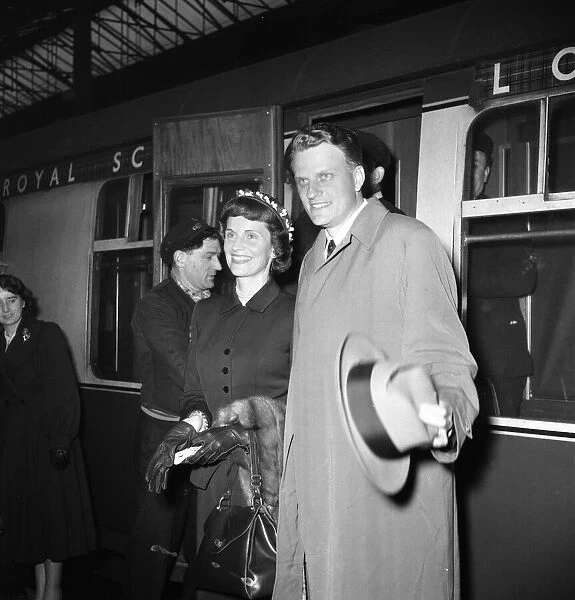 American evangelist Billy Graham arrives with his wife Ruth at Euston Station in London