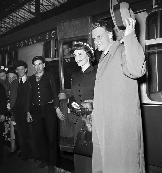 American evangelist Billy Graham arrives with his wife Ruth at Euston Station in London