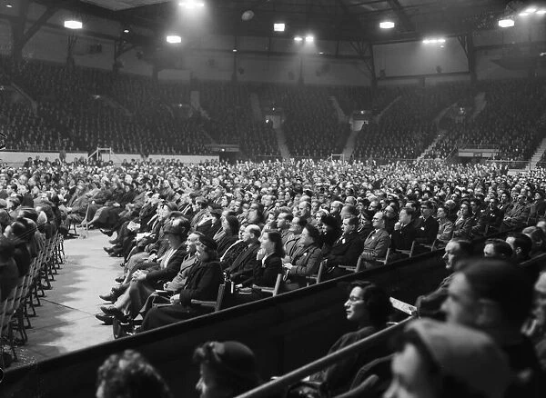 American evangelist Billy Graham speaks to the crowd at the Harringay Arena in North