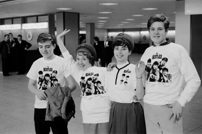 Framed Print : American fans wearing Beatles t shirts await the arrival of their heroes at New York