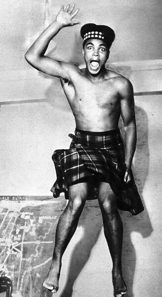American heavyweight boxer Cassius Clay, dressed in tartan kilt and glengarry hat