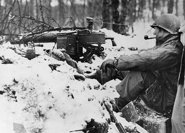 American infantryman calmly smokes a pipe at his snow covered post near a machine gun