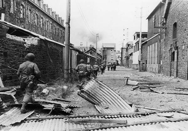 American infantrymen edge their way through the streets of Saint-Malo, in Brittany