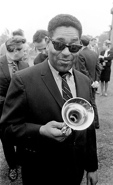 American jazz musician Dizzy Gillespie holding his trumpet at Fort Belvedere near Ascot