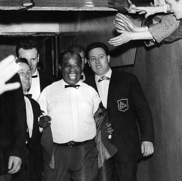 American jazz musician Louis Armstrong emerges from the players tunnel at Ibrox Stadium