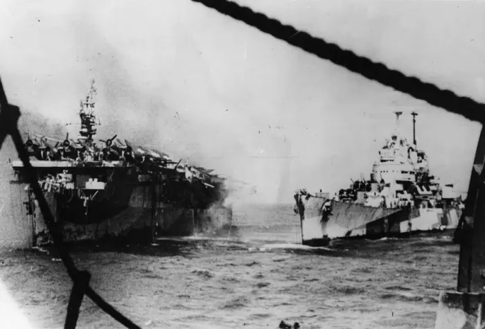 Framed Print : An American Pacific Fleet cruiser pours steams of water into the stricken light aircraft