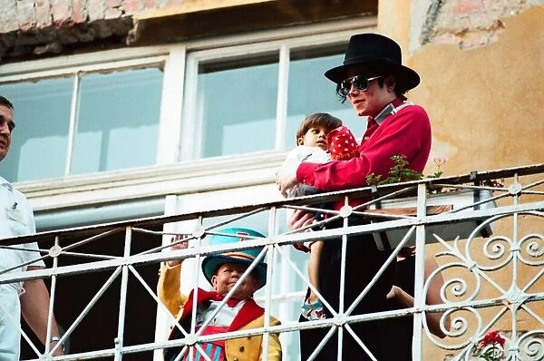 American pop singer Michael Jackson with young orphan Bela Farkas posing on a hotel