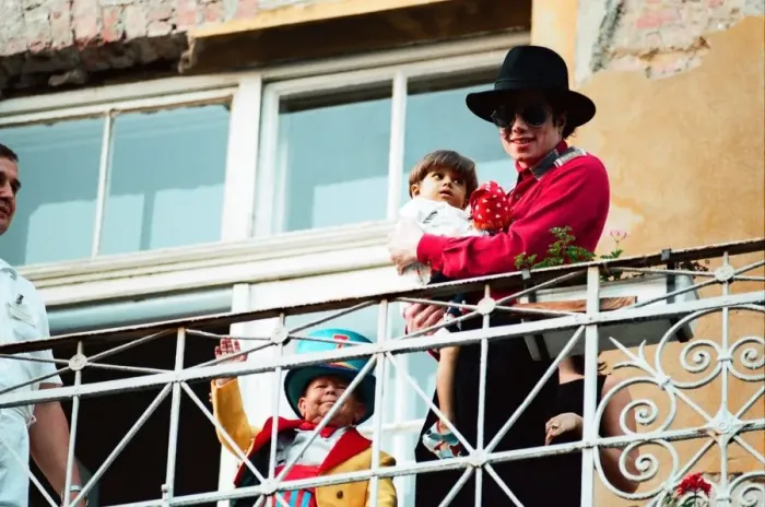 Framed Print : American pop singer Michael Jackson with young orphan Bela Farkas posing on a hotel