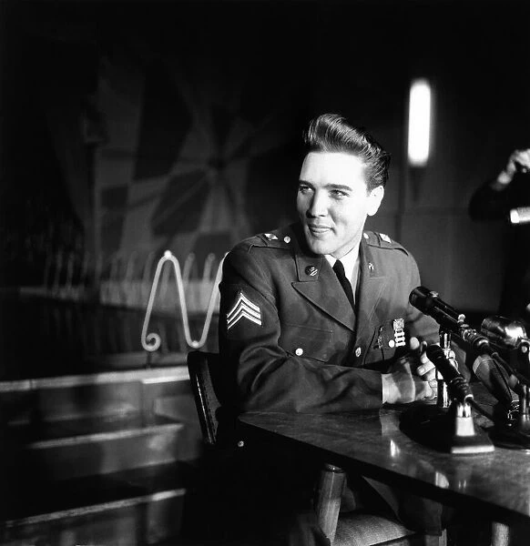 American rock and roll singer and musician Elvis Presley pictured wearing army uniform as