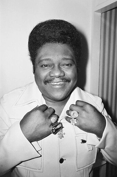 American rock and roll singer and musician Fats Domino shows off his diamond rings in his