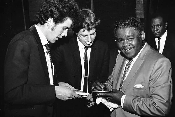 American rock and roll star Fats Domino signs autographs for fans on the stage of