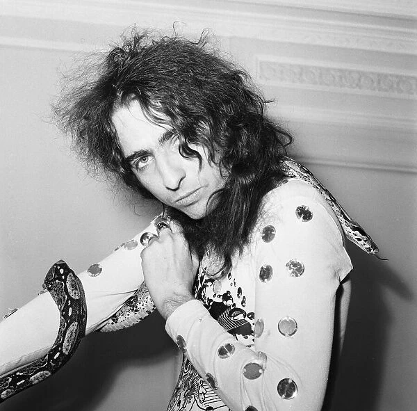 American rock singer Alice Cooper poses with his snake in London on his Love It To Death