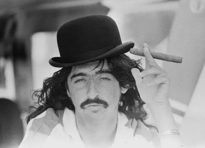 Framed Print : American rock singer Alice Cooper wearing a bowler hat and smoking a cigar during his Framed Print : American rock singer Alice Cooper wearing a bowler hat and smoking a cigar during his
