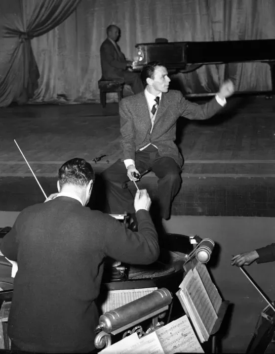 Framed Print : American singer and film star Frank Sinatra sitting on stage during rehearsals Framed Print : American singer and film star Frank Sinatra sitting on stage during rehearsals
