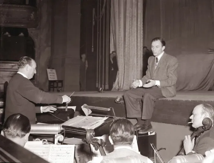Framed Print : American singer and film star Frank Sinatra sitting on stage during rehearsals