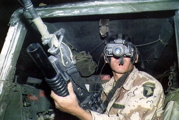 An American soldier looking through a night vision scope