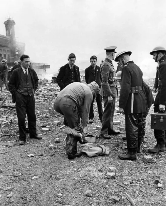 Framed Print : The American soldier stripping his outer garments amid the scene of a V1 flying bomb Framed Print : The American soldier stripping his outer garments amid the scene of a V1 flying bomb