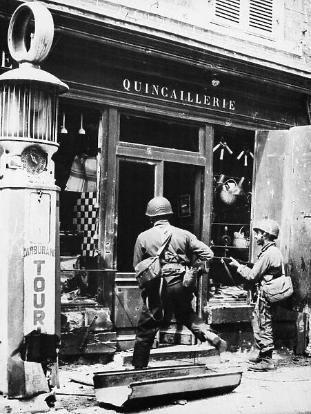 American soldiers search for snipers in St. Mere Eglise, Cherbourg. June 14th 1944