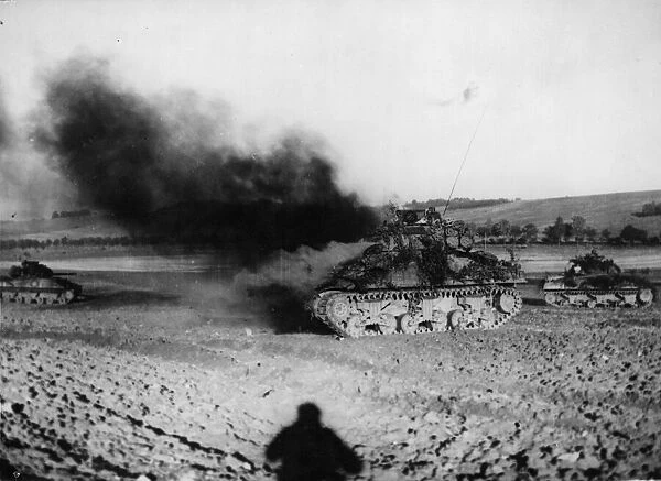 An American tank burns furiously after being taken out by a German tank in France