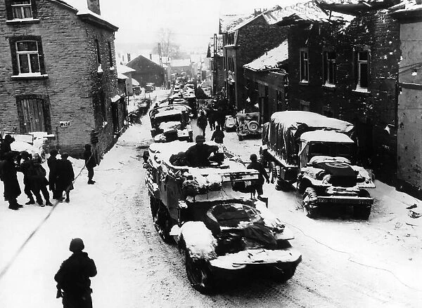 American troops pass through snow-covered street in Lierheux Belgium during WW2