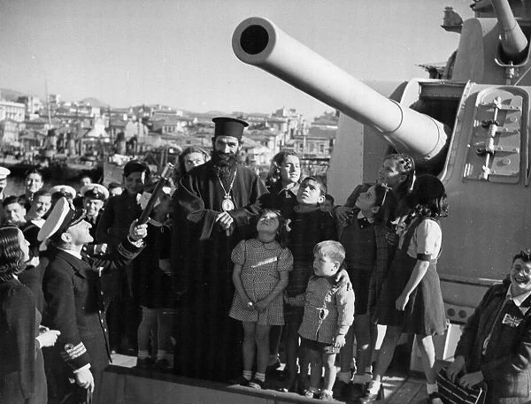 Anchored at Piraeus, the crew or HMS Ajax gave a party to Greek children to celebrate