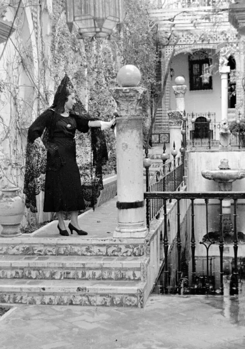 Framed Print : An Andalusian woman wearing black veil and standing on a balcony in Seville
