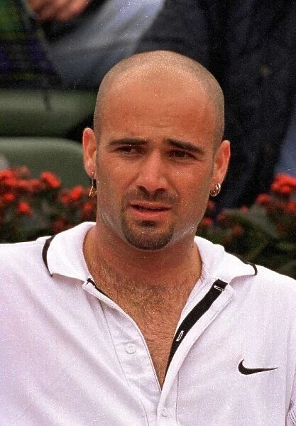Andre Agassi tennis star in action in the rain during the French Open tennis tournament
