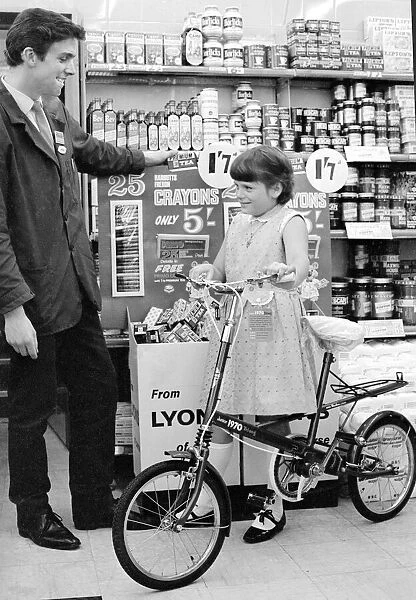 Angela Moore is pictured in a Coventry store with her new bicycle which she won in a