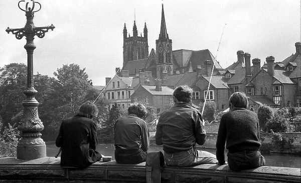 Angling. Young boys sitting on a bridge parapet fishing in the River Leam at Leamington