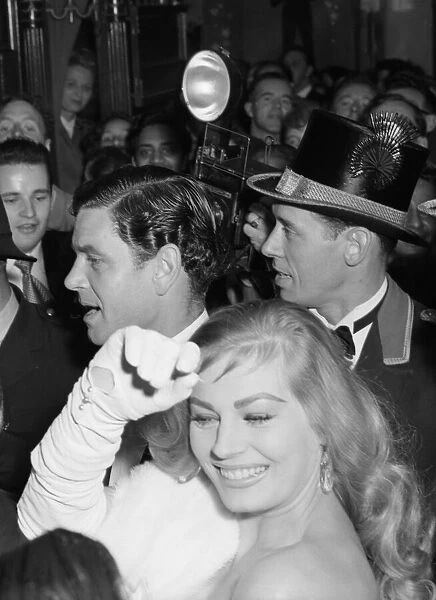 Anita Ekberg and Anthony Steele caught in the surging crowds outside the Empire Theatre