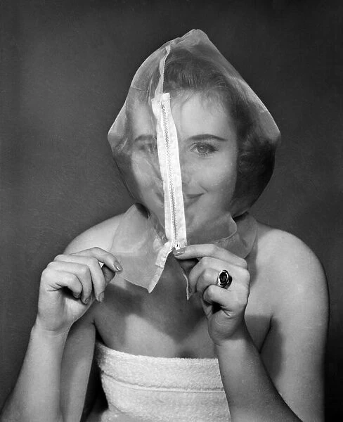 Ann Cave, model, poses with a make up mask, 29th October 1957