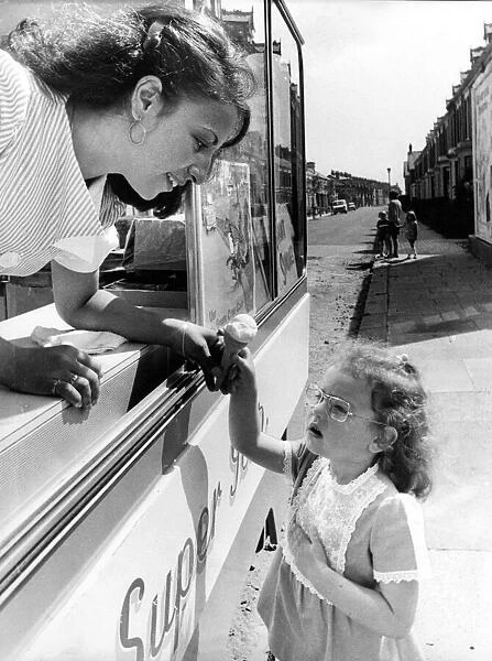 Anna Kane, with her ice cream van, helps little Mandy Harkness to learn the Green Cross