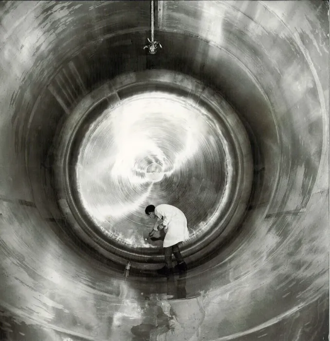 Framed Print : Ansells Brewery. A technician carrying out routine surface examination inside one