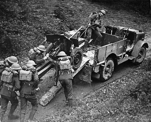 Anti tank gun being unloaded from a transport truck at the double to ready for action at